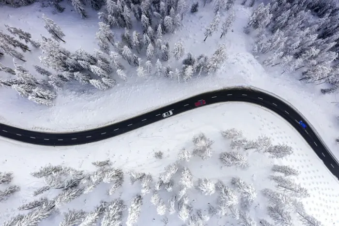 Framed Print : Aerial view of cars traveling on winding mountain road crossing the snow capped woods in Framed Print : Aerial view of cars traveling on winding mountain road crossing the snow capped woods in