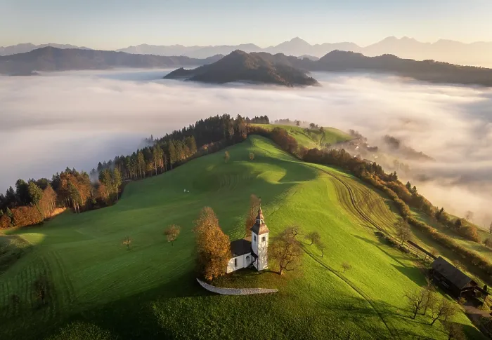 Framed Print : Aerial view of the Church of St. Thomas and the Kamink Savinja Alps in autumn, Skofja Loka, Slovenia Framed Print : Aerial view of the Church of St. Thomas and the Kamink Savinja Alps in autumn, Skofja Loka, Slovenia