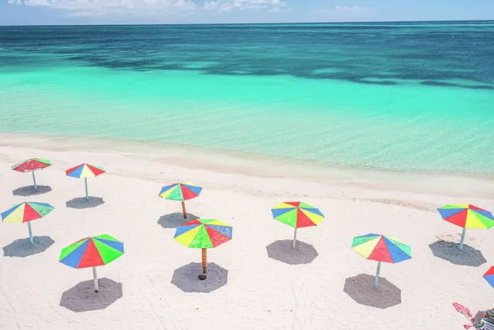 Framed Print : Aerial view of colorful beach umbrellas of a tourist resort on a beach washed by Caribbean Sea, Antigua, Antigua & Barbuda Framed Print : Aerial view of colorful beach umbrellas of a tourist resort on a beach washed by Caribbean Sea, Antigua, Antigua & Barbuda
