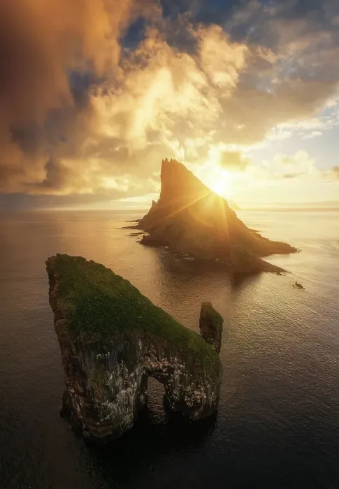 Framed Print : Aerial view of a colorful sunset behind the cliffs of Drangarnir after the storm cleared. Vagar, Faroe Islands Framed Print : Aerial view of a colorful sunset behind the cliffs of Drangarnir after the storm cleared. Vagar, Faroe Islands
