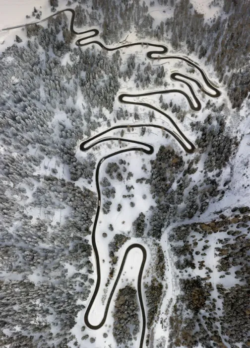 Framed Print : Aerial view of curves of the Maloja pass after a snowfall, Maloja Pass, Bregaglia Valley