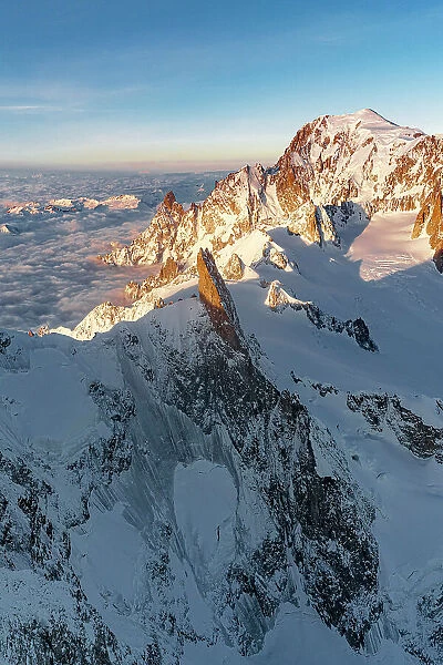 Aerial view of Dent du Geant rock pinnacle in Mont Blanc Massif covered with snow at dawn, Chamonix, Haute Savoie, France
