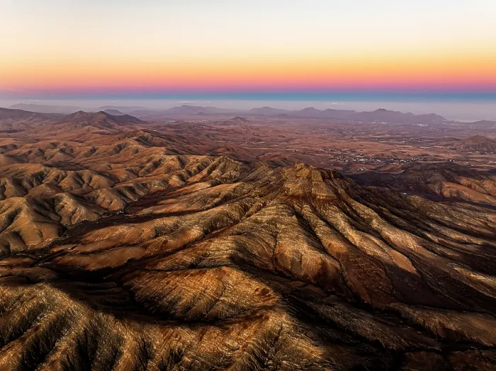Framed Print : Aerial view of desert mountains and Atlantic Ocean at sunset from Sicasumbre viewpoint, Fuerteventura, Canary Islands, Spain Framed Print : Aerial view of desert mountains and Atlantic Ocean at sunset from Sicasumbre viewpoint, Fuerteventura, Canary Islands, Spain