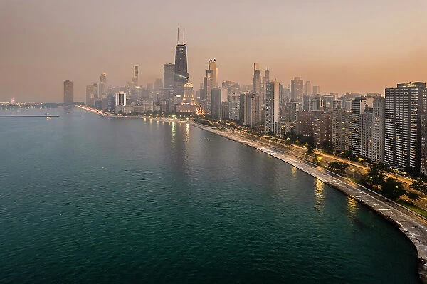 Aerial view over downtown skyline at sunset from Lake Michigan, Chicago, Illinois, USA