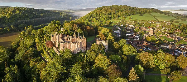 Aerial view of Dunster Castle and village, Exmoor National Park, Somerset, England. Autumn (October) 2022