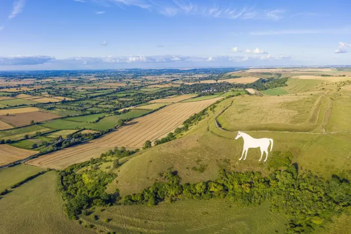 Framed Print : Aerial view of the famous White Horse below Bratton Camp, an Iron Age hillfort near