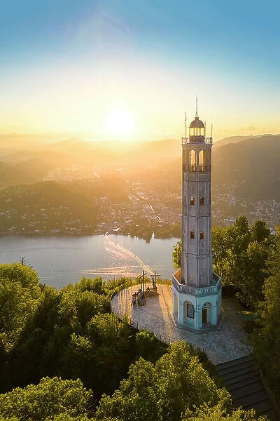 Aerial view of the Faro Voltiano (Volta Lighthouse) of Brunate overlooking Como and Como Lake in summer at sunset. Brunate, Province of Como, Lombardy, Italy