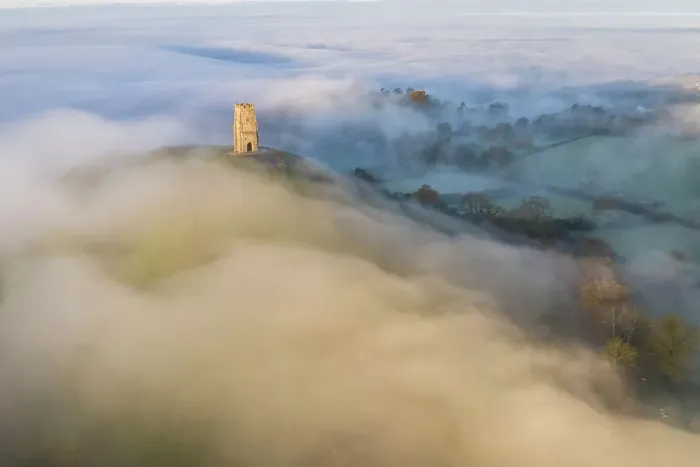 Framed Print : Aerial view of Glastonbury Tor surrounded by morning mist, Glastonbury, Somerset, England. Autumn (November) 2022