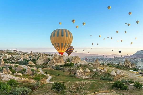 Aerial view of hot air balloon over rock formations at dawn, Goreme, Goreme Historical National Park, Nevsehir District, Nevsehir Province, UNESCO, Cappadocia, Central Anatolia Region, Turkey
