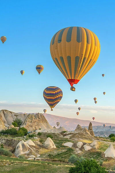 Aerial view of hot air balloon over rock formations at dawn, Goreme, Goreme Historical National Park, Nevsehir District, Nevsehir Province, UNESCO, Cappadocia, Central Anatolia Region, Turkey