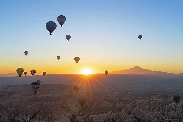 Aerial view of hot air balloons and Mount Erciyes at sunrise, Goreme, Goreme Historical National Park, Nevsehir District, Nevsehir Province, UNESCO, Cappadocia, Central Anatolia Region, Turkey