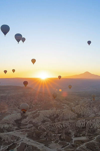 Aerial view of hot air balloons and Mount Erciyes at sunrise, Goreme, Goreme Historical National Park, Nevsehir District, Nevsehir Province, UNESCO, Cappadocia, Central Anatolia Region, Turkey