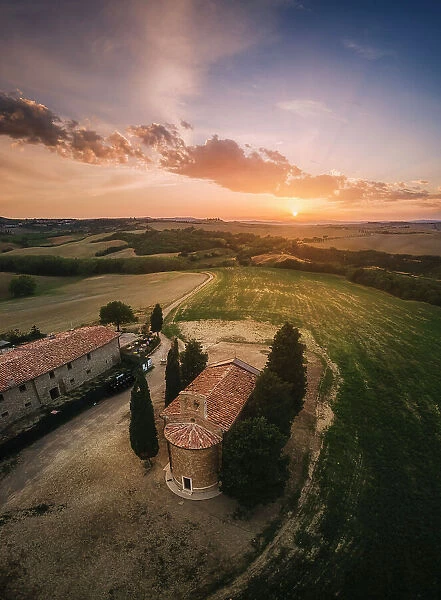 An aerial view of the iconic Chapel of Madonna di Vitaleta on a hazy late summer evening. Val d'Orcia, Tuscany, Italy