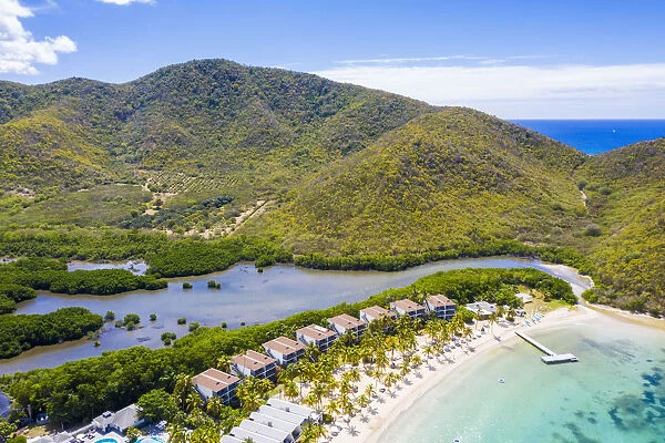 Aerial view of luxury resort on palm-fringed beach from above, Carlisle Bay, Antigua