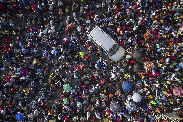 Aerial view of millions of people rush to board a ferry with their belongings to get home