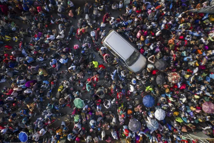 Framed Print : Aerial view of millions of people rush to board a ferry with their belongings to get home Framed Print : Aerial view of millions of people rush to board a ferry with their belongings to get home