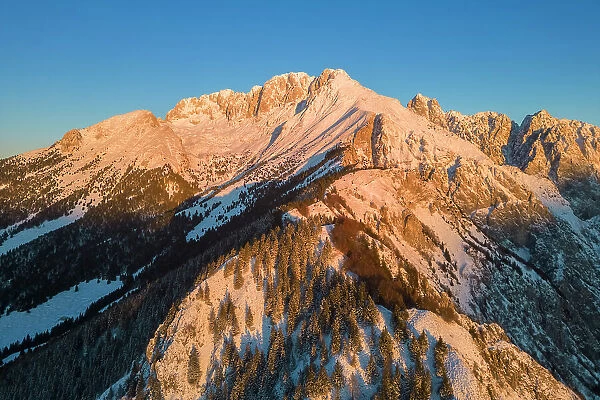 Aerial view of Monte Gulter and the Presolana massif after a winter snowfall at sunrise. Presolana pass, Castione della Presolana, Seriana Valley, Bergamo province, Lombardy, Italy