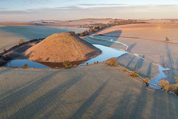 Aerial view of Neolithic Silbury Hill on a frosty morning, Avebury, Wiltshire, England. Winter (February) 2023