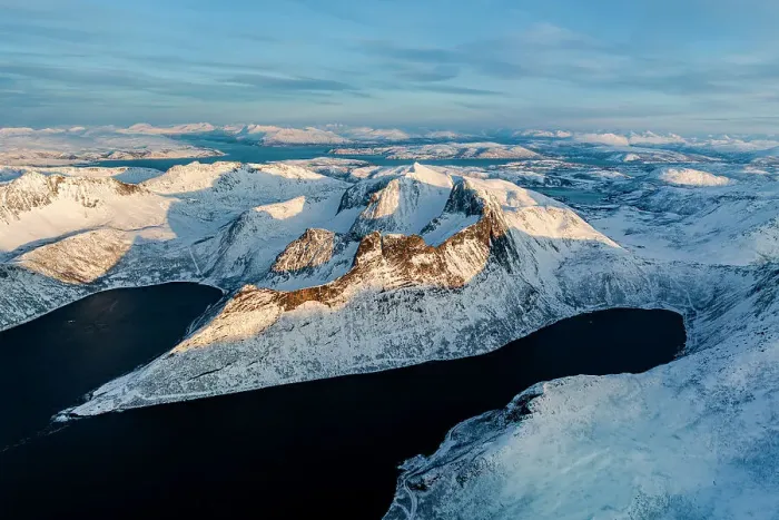 Framed Print : Aerial view of Oksfjord village and Grytetippen mountain covered with snow overlooking the cold sea, Senja, Troms county, Norway Framed Print : Aerial view of Oksfjord village and Grytetippen mountain covered with snow overlooking the cold sea, Senja, Troms county, Norway