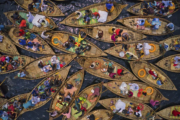 Aerial view of people sitting on traditional boats at Old Dhaka river port along