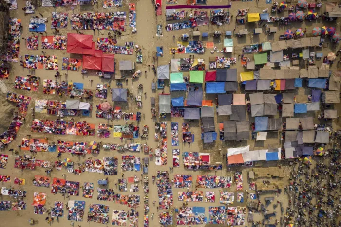 Framed Print : Aerial view of people trading at weekly market, seeking out products in the city of Framed Print : Aerial view of people trading at weekly market, seeking out products in the city of