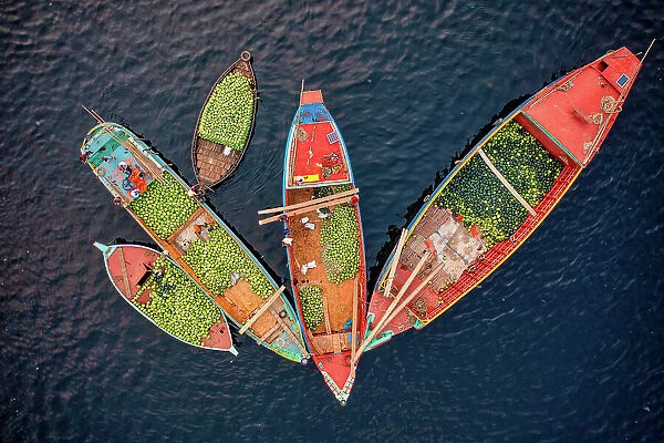 Aerial view of people working on commercial boats with fruits, Buriganga river, Keraniganj, Dhaka, Bangladesh