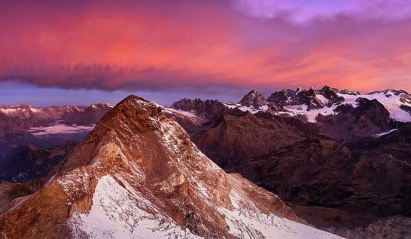 Aerial view of Pizzo Scalino at sunrise with view on Bernina group. Valmalenco, Valtellina, Lombardy, Italy
