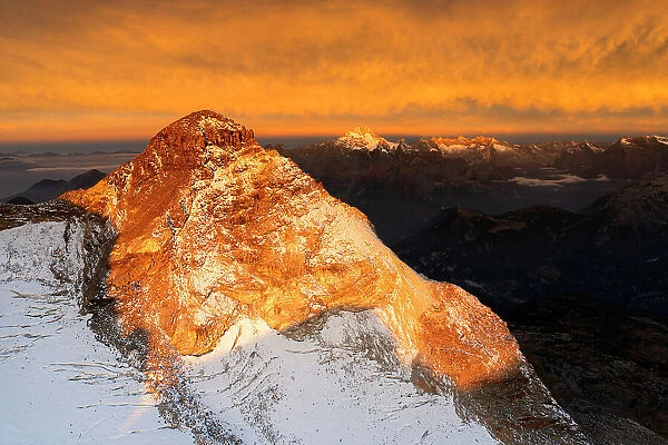 Aerial view of Pizzo Scalino at sunrise with view on Mount Disgrazia. Valmalenco, Valtellina, Lombardy, Italy