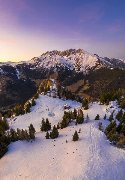 Aerial view of the Presolana covered in snow from Mount Scanapa during a winter sunset