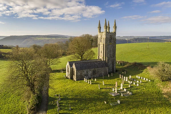 Aerial view of the pretty Church of All Saints in Dunterton, Devon, England. Spring (March) 2021
