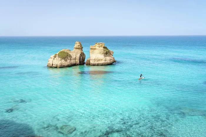 Framed Print : Aerial view of two rock formations in crystal-clear turquoise waters, located off the coast of Salento, Puglia, Italy. Two Sisters. Paddle boarding Framed Print : Aerial view of two rock formations in crystal-clear turquoise waters, located off the coast of Salento, Puglia, Italy. Two Sisters. Paddle boarding