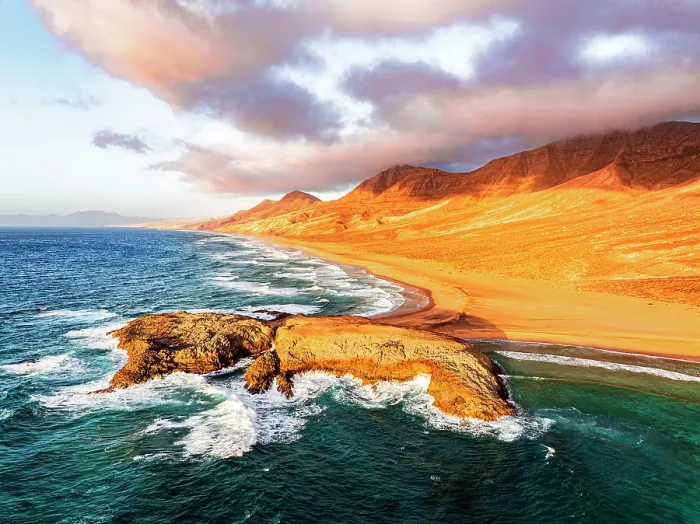 Framed Print : Aerial view of rocky islet at Cofete beach washed by ocean waves, Jandia Natural Park, Fuerteventura, Canary Islands, Spain Framed Print : Aerial view of rocky islet at Cofete beach washed by ocean waves, Jandia Natural Park, Fuerteventura, Canary Islands, Spain