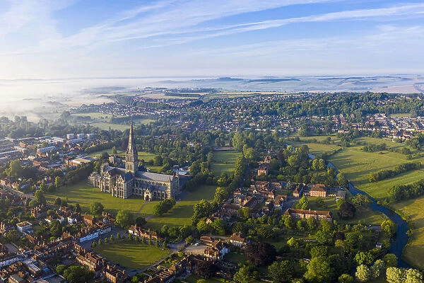 Aerial view over Salisbury and Salisbury Cathedral on a misty summer morning, Salisbury