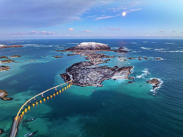 Aerial view of a scenic bridge crossing the frozen arctic sea at dusk, Sommaroy, Troms county, Norway