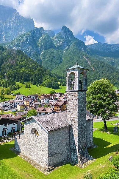 Aerial view of the small church called Cesul√¨ in Colere town with view of the north face of the Presolana mountain in summer. Colere, Val di Scalve, Bergamo district, Lombardy, Italy