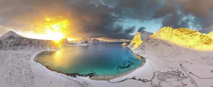 Framed Print : Aerial view of the snowy Haukland beach and turquoise water of a fjord under a burning sky at dawn, Lofoten Islands, Norway