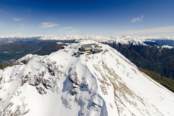 Aerial view of snowy peaks of Grignone with Brioschi Refuge on the summit Lecco Province
