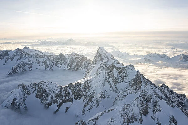 Aerial view of snowy peaks of Mont Blanc and Dent du Geant during sunrise, Courmayeur