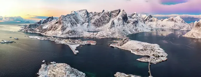 Framed Print : Aerial view of the snowy Reinebringen mountain and Reine Bay under scenic clouds at dawn, Reine, Lofoten Islands, Norway Framed Print : Aerial view of the snowy Reinebringen mountain and Reine Bay under scenic clouds at dawn, Reine, Lofoten Islands, Norway