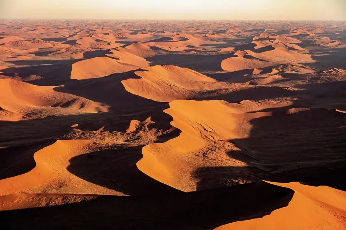 Framed Print : Aerial view of sprawling orange sand dunes at sunrise, Sossusvlei, Namib-Naukluft National Park, Namib Desert, Namibia