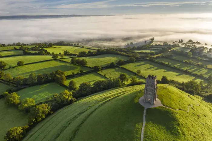 Framed Print : Aerial view of St Michaels Tower on Glastonbury Tor on a misty autumn morning Framed Print : Aerial view of St Michaels Tower on Glastonbury Tor on a misty autumn morning