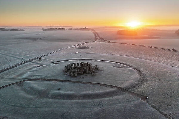 Aerial view of Stonehenge at sunrise on a frosty winter morning, Amesbury, Wiltshire, England. Winter (February) 2023