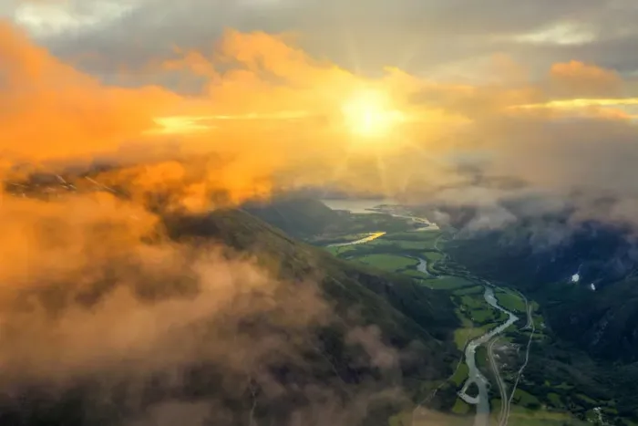 Framed Print : Aerial view of sun rays in the sunset sky lighting up the clouds over Romsdalen valley Framed Print : Aerial view of sun rays in the sunset sky lighting up the clouds over Romsdalen valley