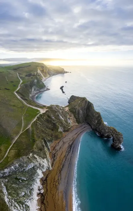 Framed Print : Aerial view at sunrise of the Durdle Door, a natural limestone arch on the Jurassic Coast Framed Print : Aerial view at sunrise of the Durdle Door, a natural limestone arch on the Jurassic Coast