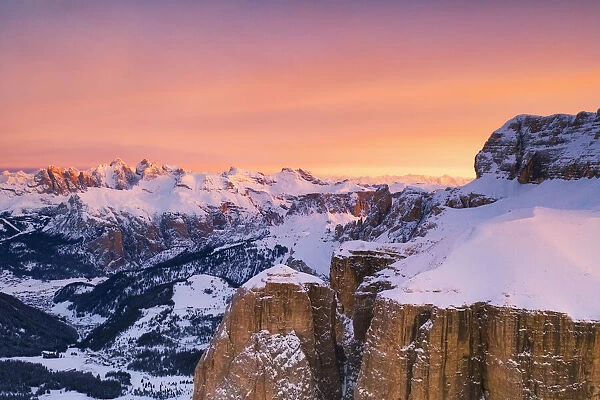 aerial view taken by drone of Sella Group mountain during a winter sunrise