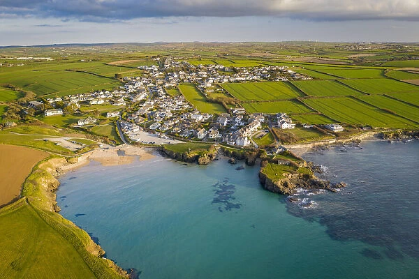 Aerial view of Trevone Beach and village in evening sunlight, Trevone, Cornwall, England