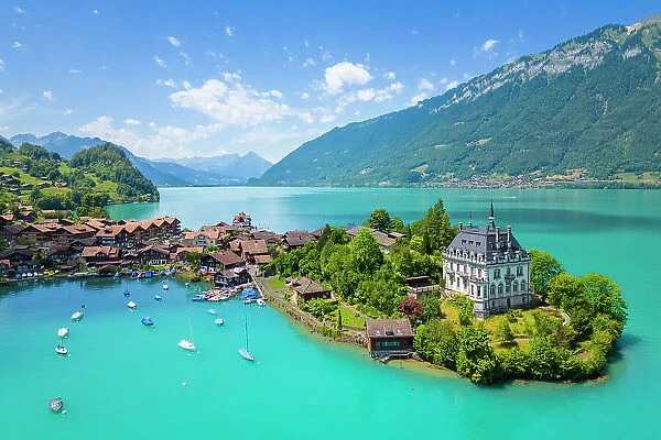 Aerial view of the village of Iseltwald and it's peninsula with the old Castle on Lake Brienz. Iseltwald, Lake Brienz, Bernese Oberland, Interlaken-Oberhasli district, Canton of Bern, Switzerland