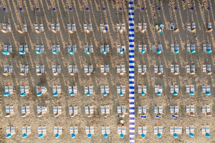 Framed Print : Aerial view of white sunbeds in a row on empty sand beach in summer, Vieste Framed Print : Aerial view of white sunbeds in a row on empty sand beach in summer, Vieste