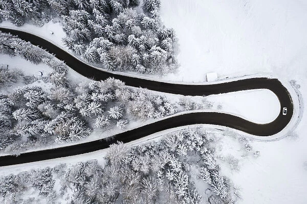 Aerial view of the winding road of the Presolana Pass after a winter snowfall