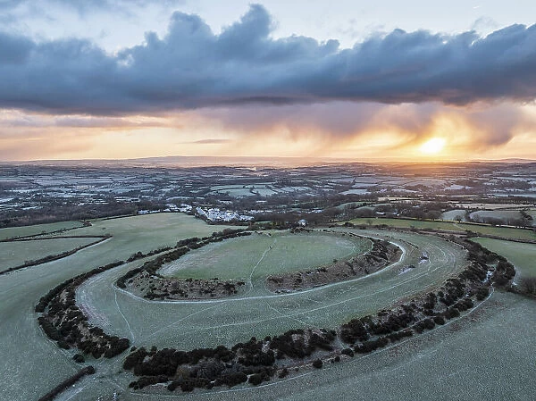 Aerial view of winter sunrise above Warbstow Bury, an Iron Age Hillfort near Davidstow in Cornwall, England. Winter (January) 2024